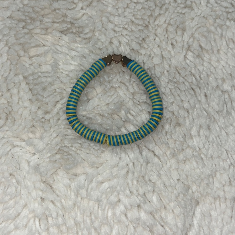 Blue and yellow bracelet with hearts in the middle